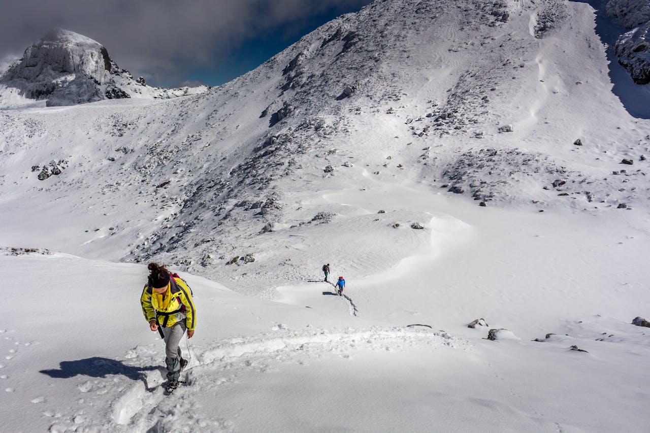 Hikers traverse a snowy mountain trail in Bulgaria’s breathtaking landscapes.